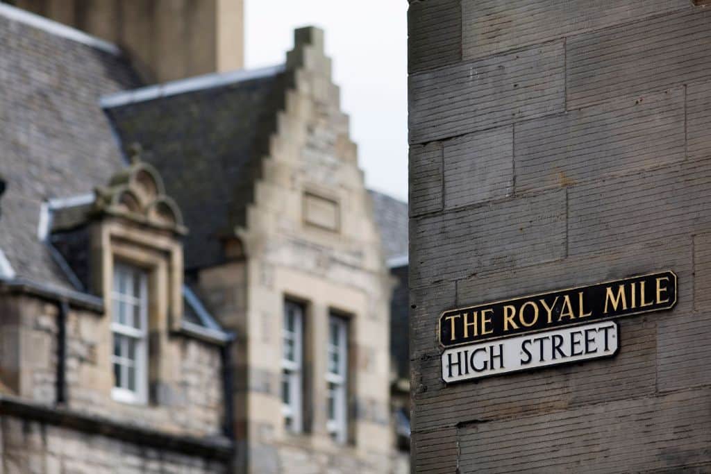Street signs on a building in Old Town that read The Royal Mile and High Street.