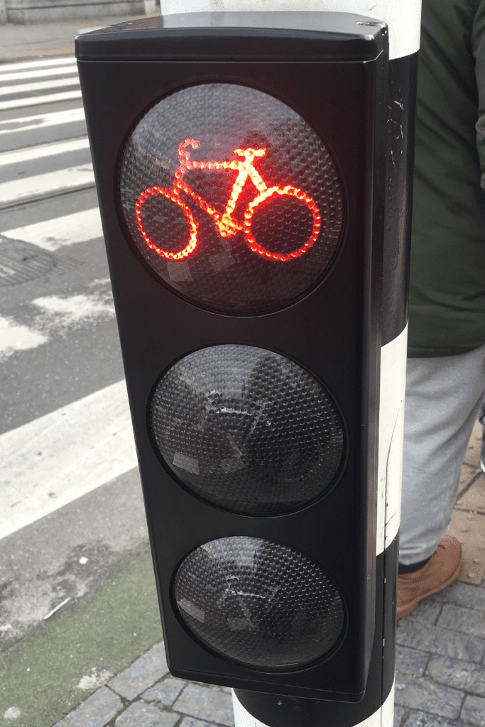 A bike traffic light in Amsterdam, the Netherlands, that is lit up red for stop.