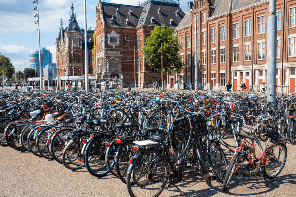 A large bike parking lot in front of Amsterdam Centraal Station, where hundreds of bikes are locked and waiting.