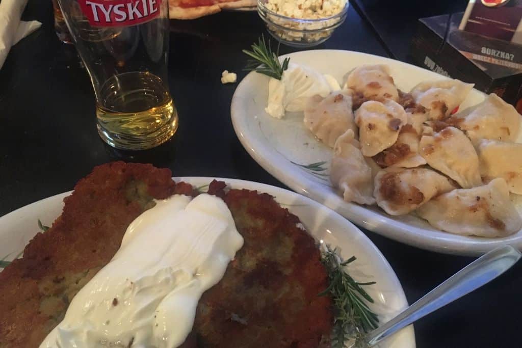 2 Days in Krakow A Polish meal we had consisting of more pierogies, potato pancakes, and Tyskie! What an incredible meal to have if you decide to spend 2 days in Krakow!