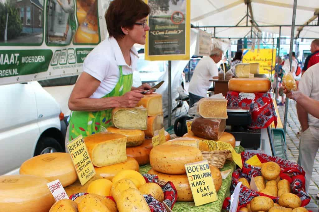 Gouda Cheese Market A woman at her stall in the Gouda Cheese Market in the Netherlands.