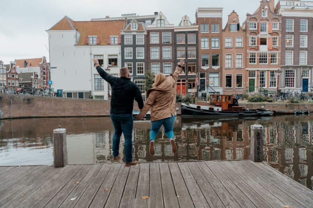 Me and my husband during our photoshoot in Amsterdam pretending to jump into the canals.