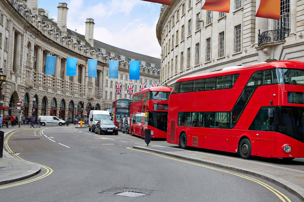 What is London Famous For Double decker busses waiting for people at the Piccadilly Circus roundabout, one of the most popular places London is known for.