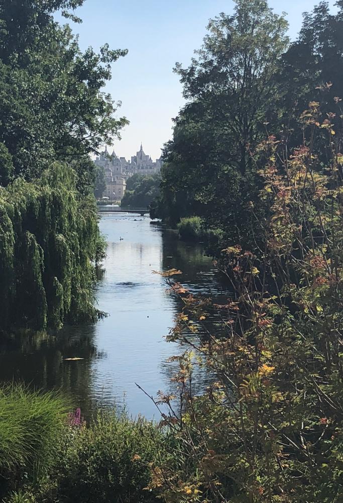 What is London Famous For The waterways in St-James Park and a view of downtown London through the trees.