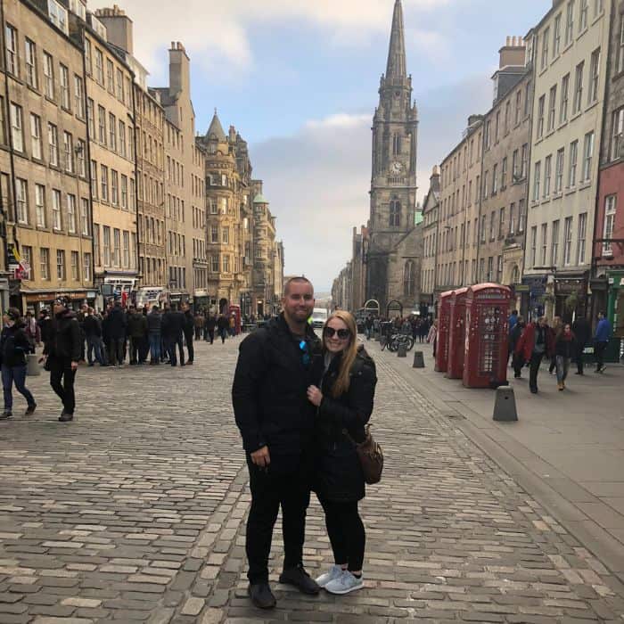Royal Mile Edinburgh Scotland Taylor and her husband dressed in black and standing in the middle of the Royal Mile in Edinburgh, Scotland. St. Giles Cathedral spire is visible in the background.