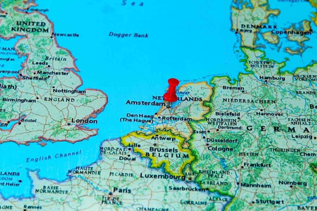 A map of Europe which shows Amsterdam with a pin in it and its proximity to Germany.