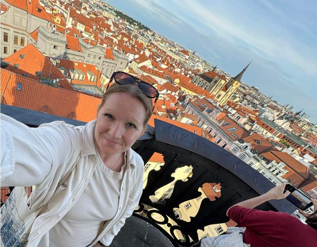 Taylor taking a selfie from a scenic observation point overlooking Prague’s historic rooftops and skyline during 3 Days in Prague.